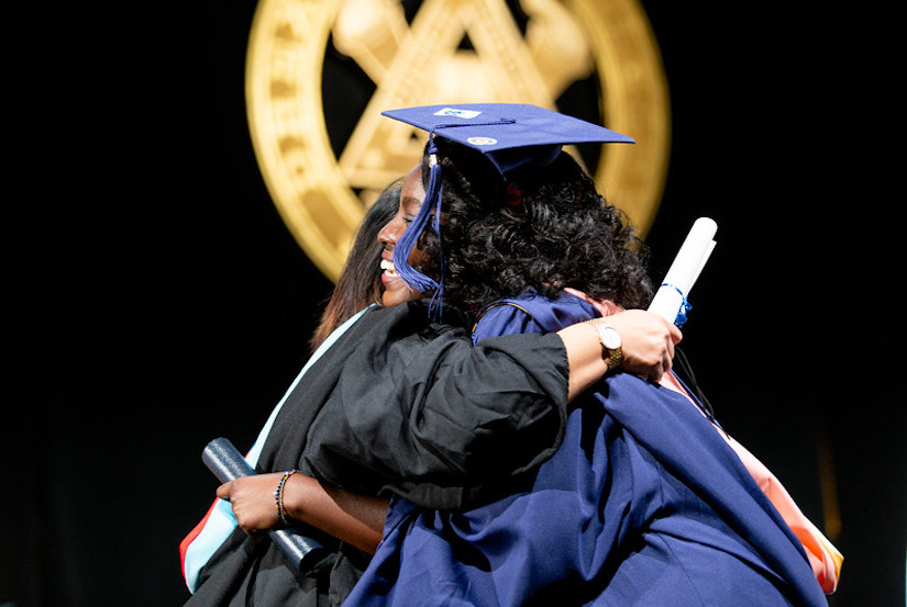 Student hugging at commencement ceremony